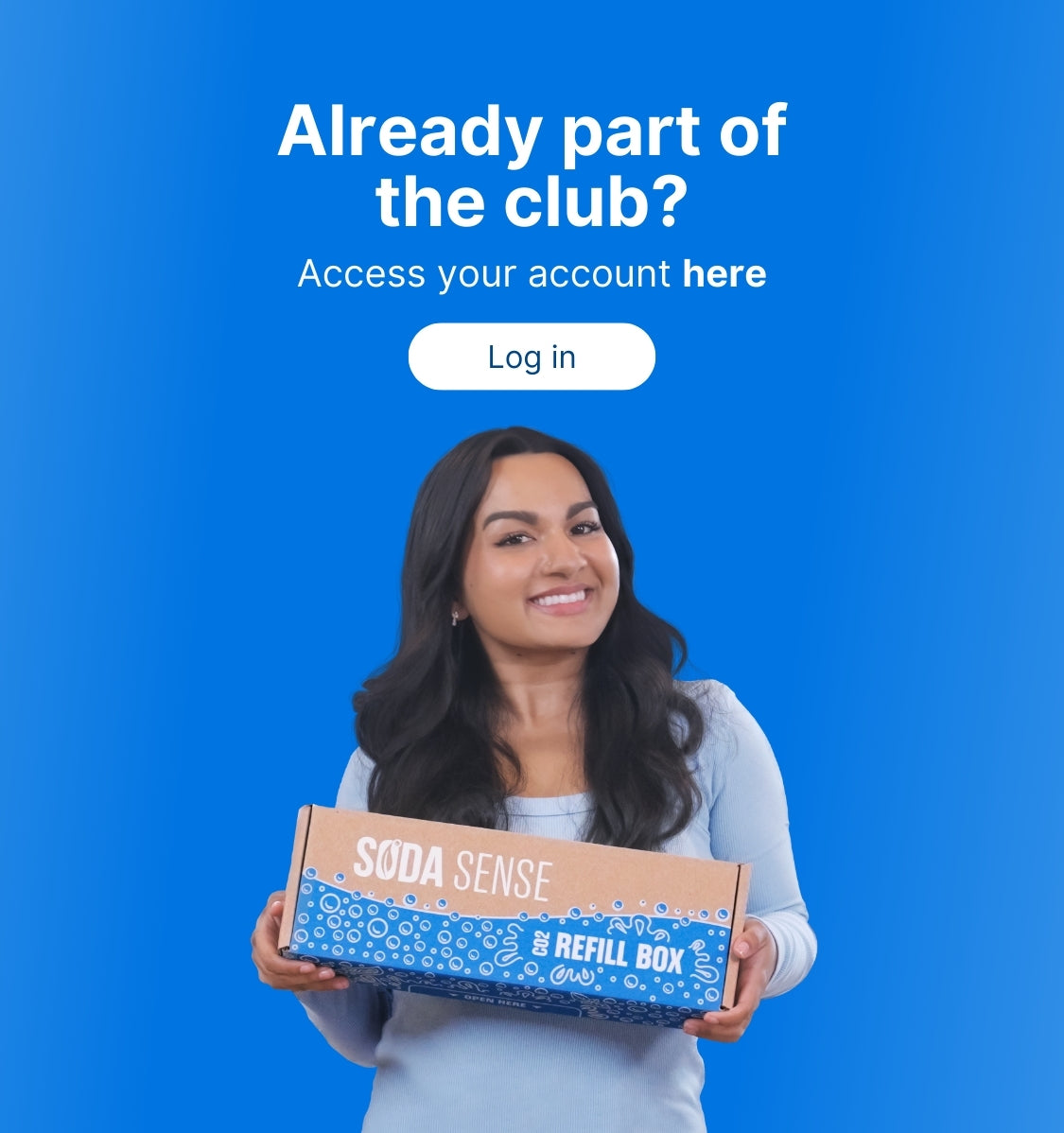 A smiling woman with long dark hair is holding a Soda Sense CO2 Refill Box against a solid blue background. White text on the left side of the image reads, 