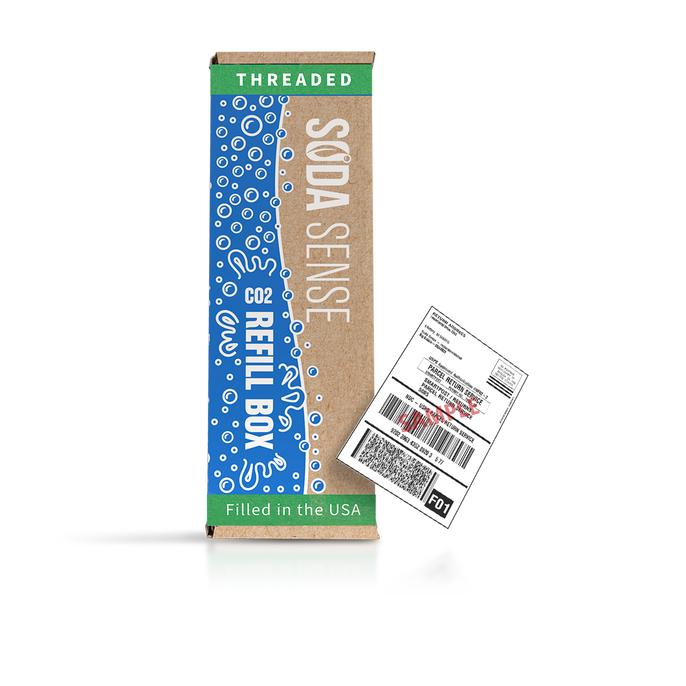 A Soda Sense CO2 Refill Box labeled 'Threaded' with a green stripe at the top. The box features blue bubbles and white text. Beside it is a shipping label.